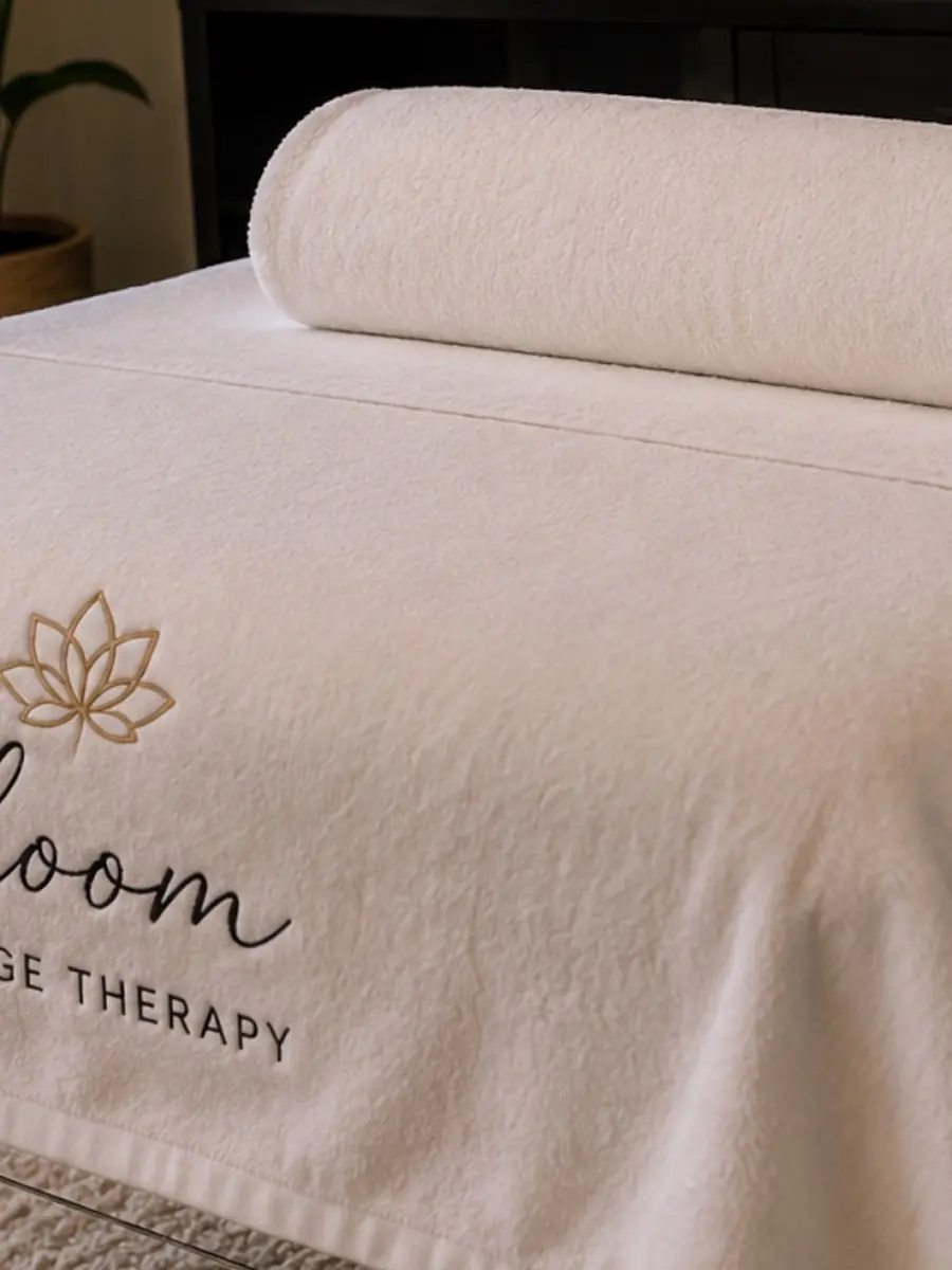 Warm corner of the treatment room with the table prepared and a plant behind
